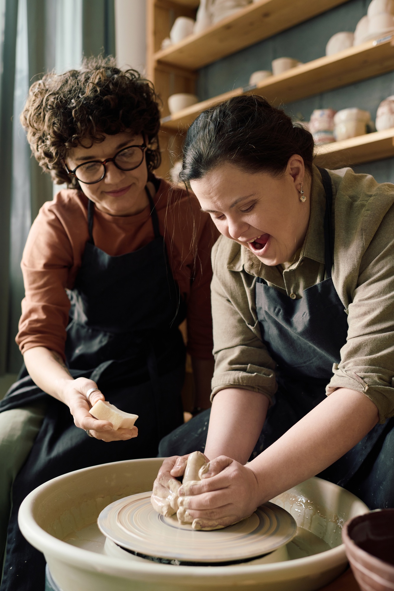 Girl With Disability Having Fun During Pottery Class